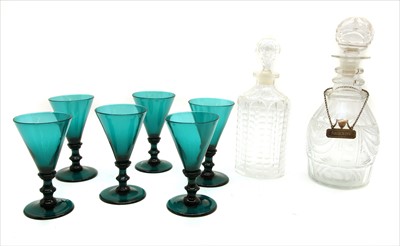 Lot 267 - A set of seven green glass wine glasses