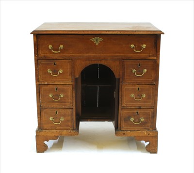 Lot 377 - A walnut kneehole desk
