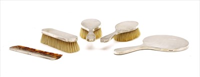Lot 125 - A five piece silver backed brush set