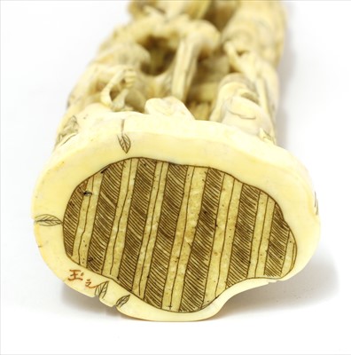 Lot 158 - A Japanese carved walrus ivory okimono