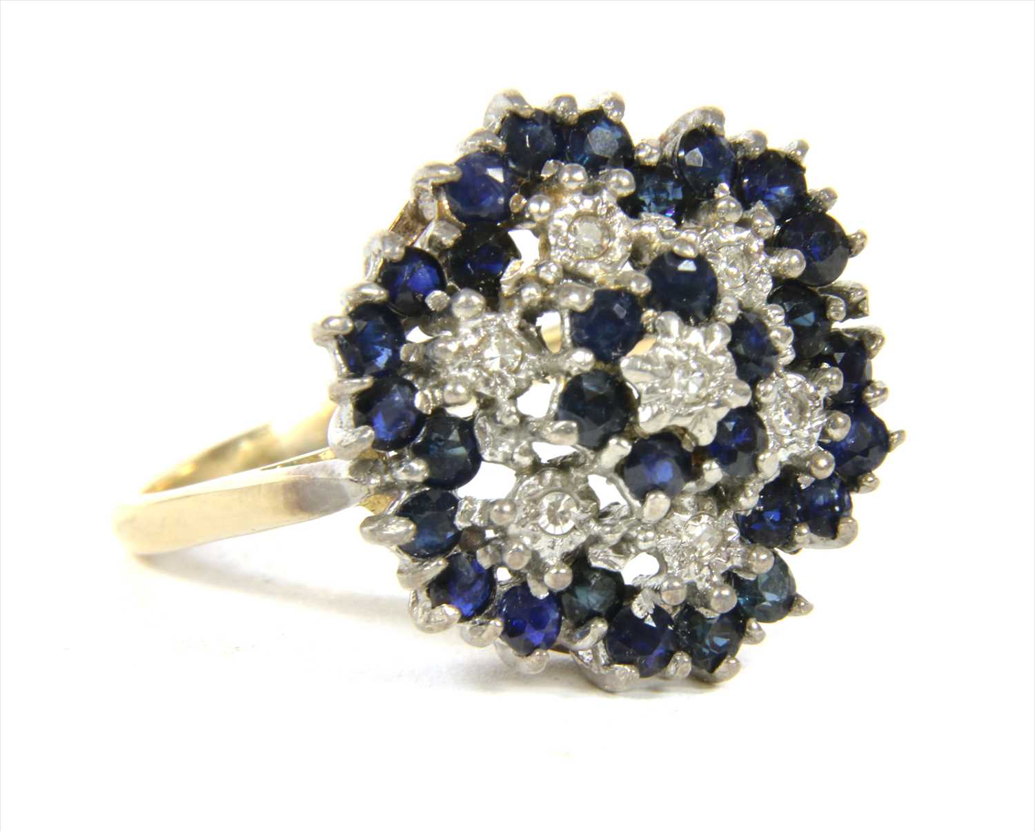 Lot 17 - A 9ct gold diamond and sapphire four tier cluster ring