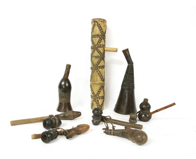 Lot 209 - Four African section wood and leather mounted water pipes