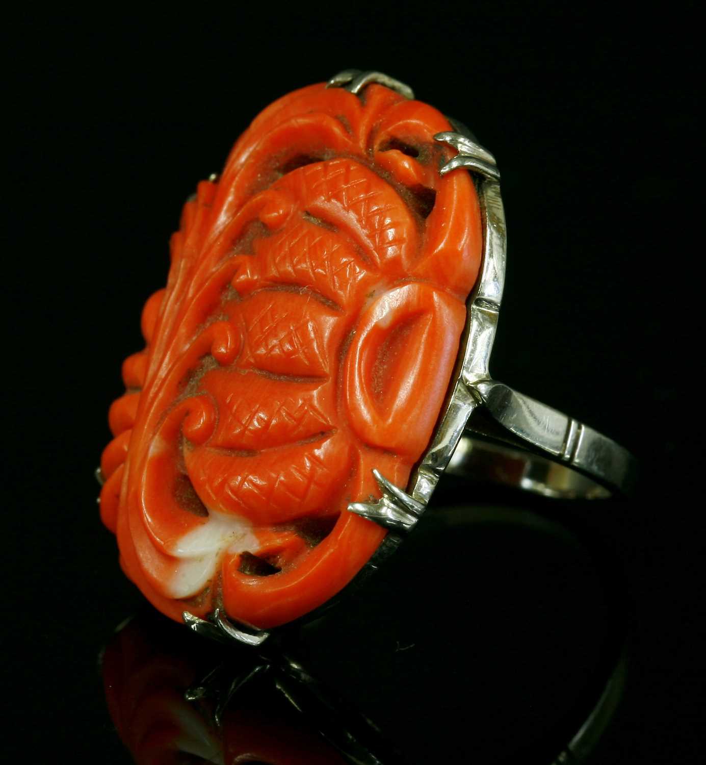 Lot 110 - A white gold carved coral ring