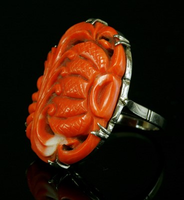 Lot 110 - A white gold carved coral ring