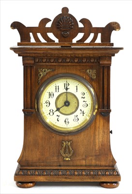 Lot 694 - A Junghans walnut cased musical mantel clock