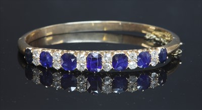 Lot 57 - A late Victorian sapphire and diamond hinged bangle, c.1890