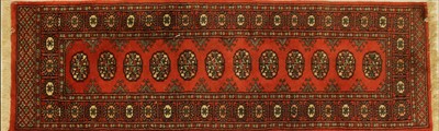 Lot 435 - A Caucasian red ground rug decorated with three rows of ghuls