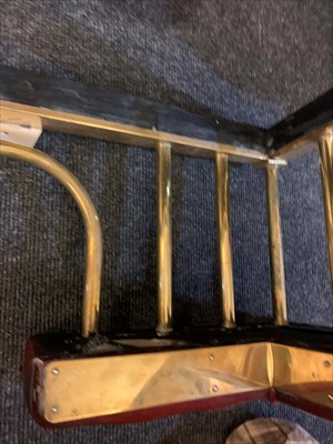 Lot 646 - A brass club fender