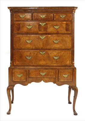 Lot 664 - A walnut chest on stand