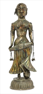 Lot 74 - An Indian white metal standing figure of a musician