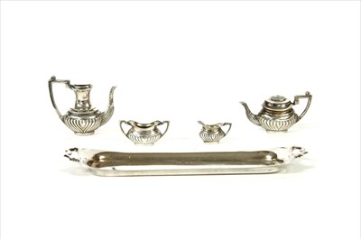 Lot 77 - A silver miniature tea set