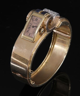 Lot 144 - A French odeonesque gold and platinum, sapphire and diamond mechanical bangle watch, c.1940