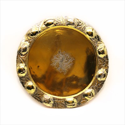 Lot 131 - A silver gilt plate having fruit and floral relief border
