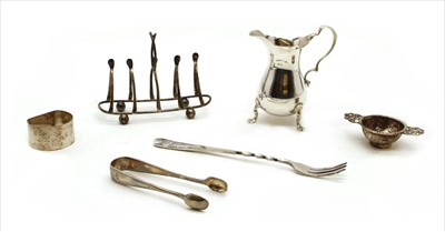 Lot 57 - A collection of silver items to include a cream jug
