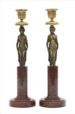 Lot 109 - A pair of gilt bronze and porphyry figural candlesticks
