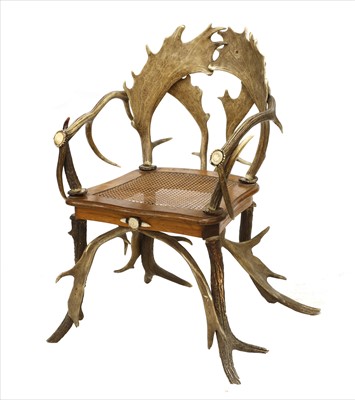 Lot 806 - A Swiss oak and antler bergère armchair
