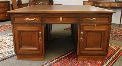 Lot 508 - An early 20th century oak partners desk