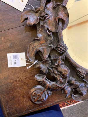 Lot 125 - A Black Forest carved wall mirror