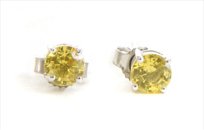 Lot 38 - A pair of white gold single stone yellow sapphire stud earrings