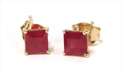 Lot 30 - A pair of gold single stone treated ruby stud earrings