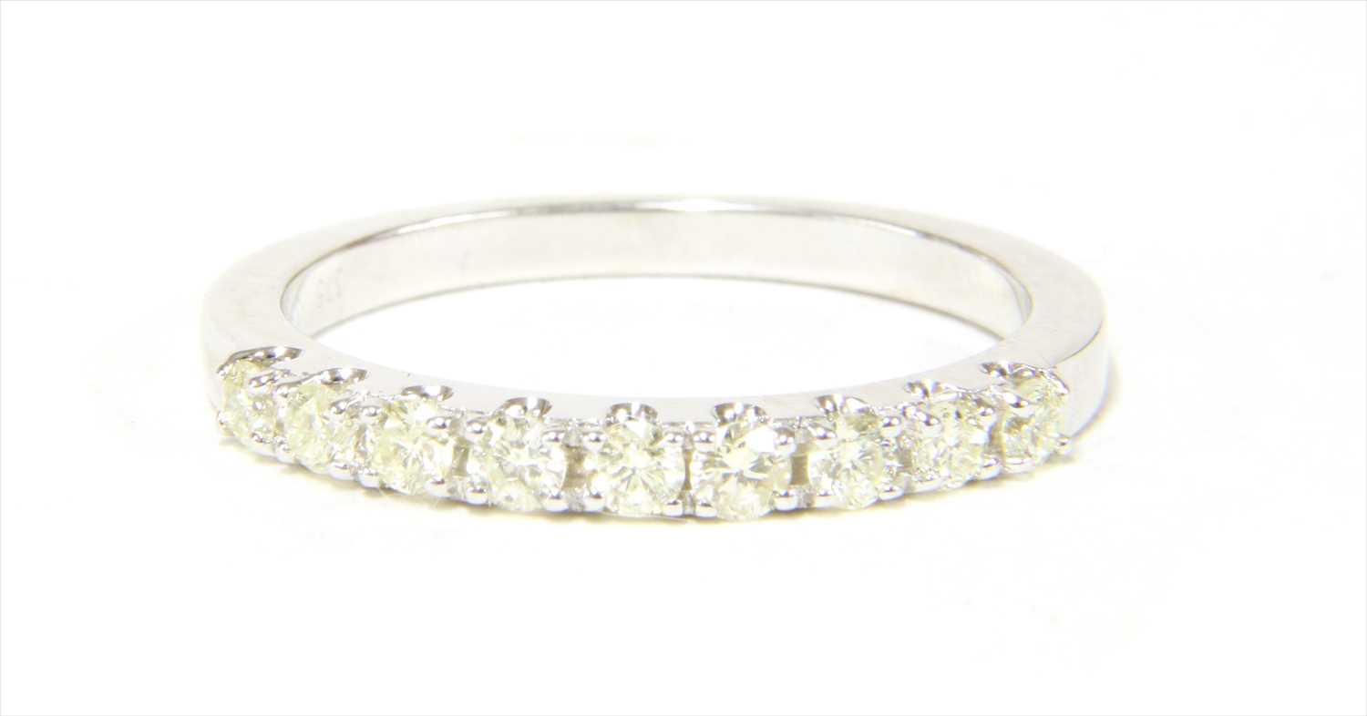 Lot 24 - A 9ct white gold half eternity ring