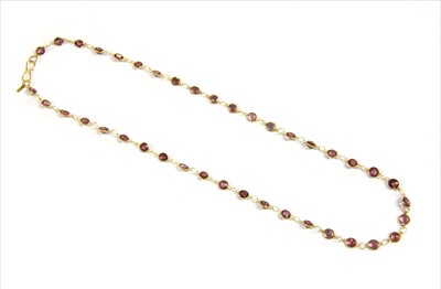 Lot 103 - A gold rhodolite garnet rivière necklace