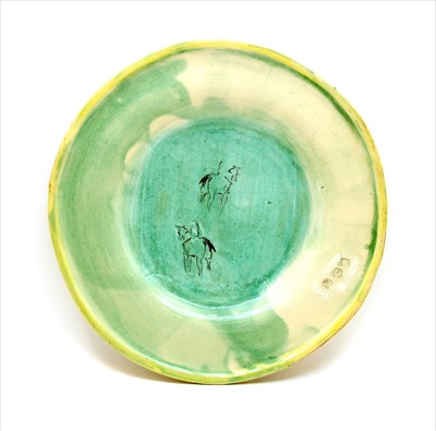 Lot 340 - A large green glazed charger
