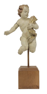 Lot 661 - A carved fruitwood and painted figure of a putto