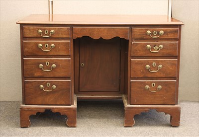 Lot 615 - An 18th century mahogany kneehole desk