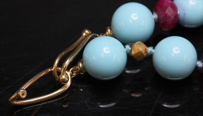 Lot 188 - A single row reconstituted turquoise, ruby and gold bead necklace