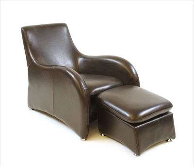 Lot 512 - A brown leather 'Loge' easy chair and ottoman