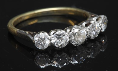 Lot 61 - A two colour gold graduated five stone diamond ring