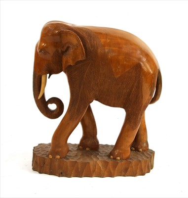 Lot 412 - A carved teak elephant