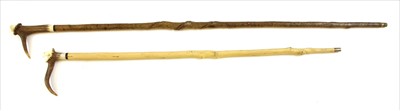 Lot 393 - Two carved antler handle walking sticks