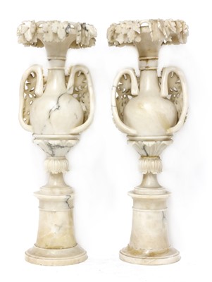 Lot 520 - A pair of alabaster candle stands