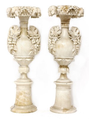 Lot 520 - A pair of alabaster candle stands
