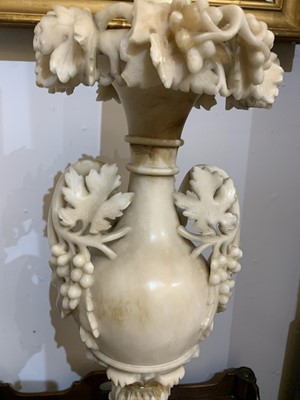 Lot 520 - A pair of alabaster candle stands