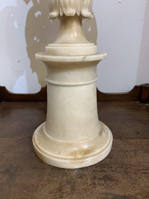 Lot 520 - A pair of alabaster candle stands