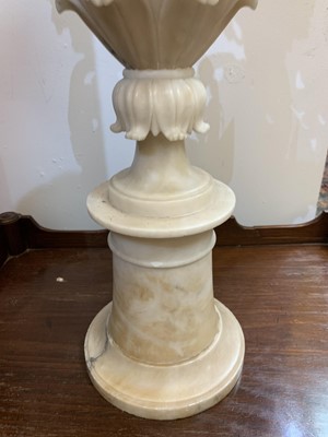 Lot 520 - A pair of alabaster candle stands