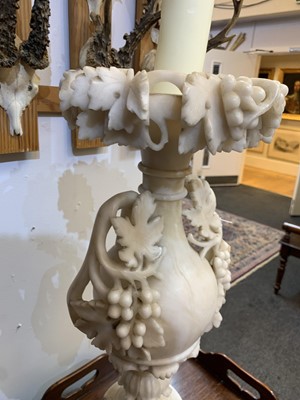 Lot 520 - A pair of alabaster candle stands