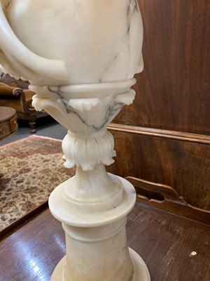 Lot 520 - A pair of alabaster candle stands