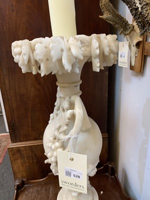 Lot 520 - A pair of alabaster candle stands