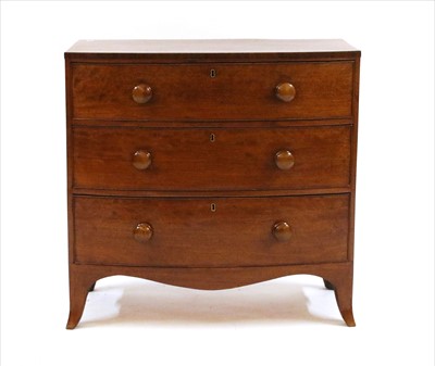 Lot 601 - A bowfront mahogany chest of three long drawers