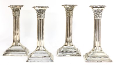 Lot 52 - A set of four silver candlesticks
