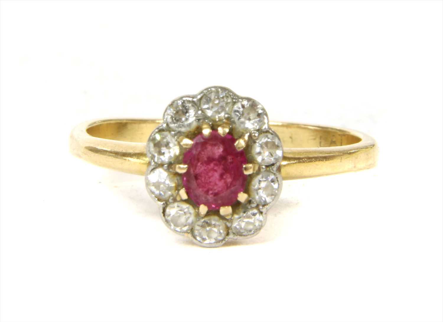 Lot 8 - A gold ruby and diamond cluster ring