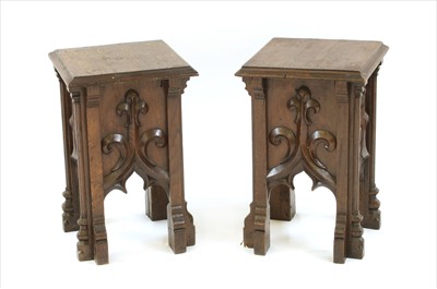 Lot 580 - A pair of carved oak ecclesiastical side tables