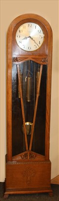 Lot 511 - A 1930s oak cased longcase clock