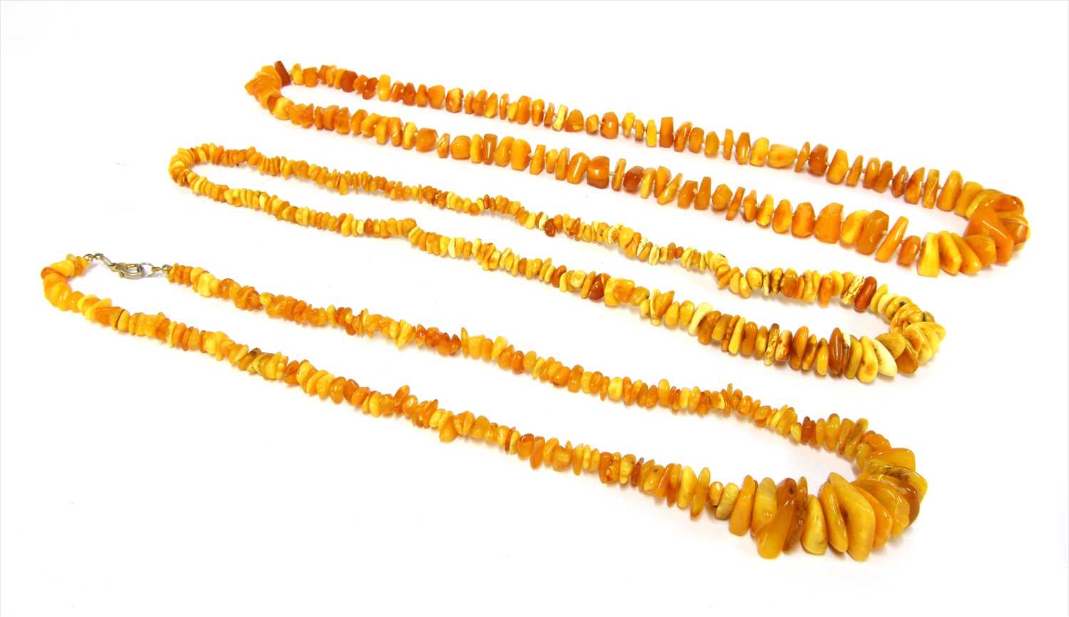 Lot 19 - Three  graduated butterscotch amber tumbled bead necklaces