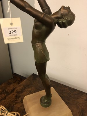 Lot 329 - An Art Deco patinated spelter and onyx figural table lamp