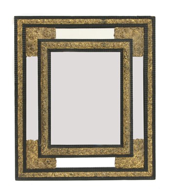 Lot 518 - An ebonised and gilt rectangular mirror